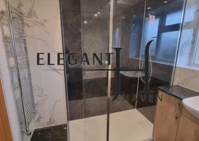 Minimalist bathroom design with glass shower panels in North London