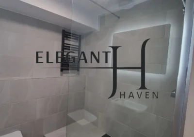 High-quality bathroom remodel with glass panels and marble tiles.