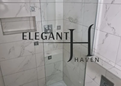 Modern bathroom installation with sleek cabinetry and glass shower.